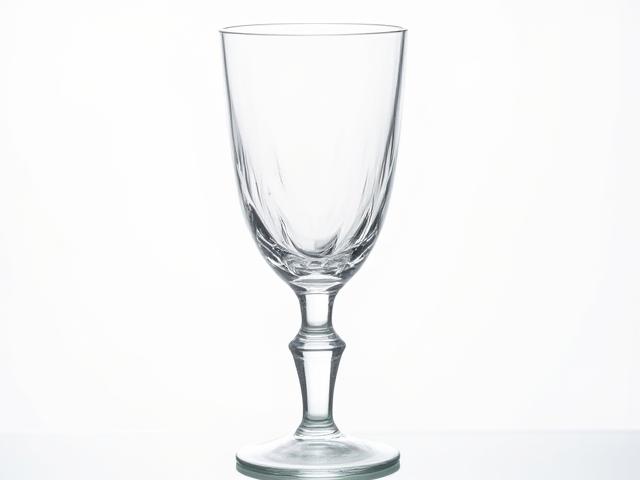 Transparent handcrafted glass goblet sparkling with refraction